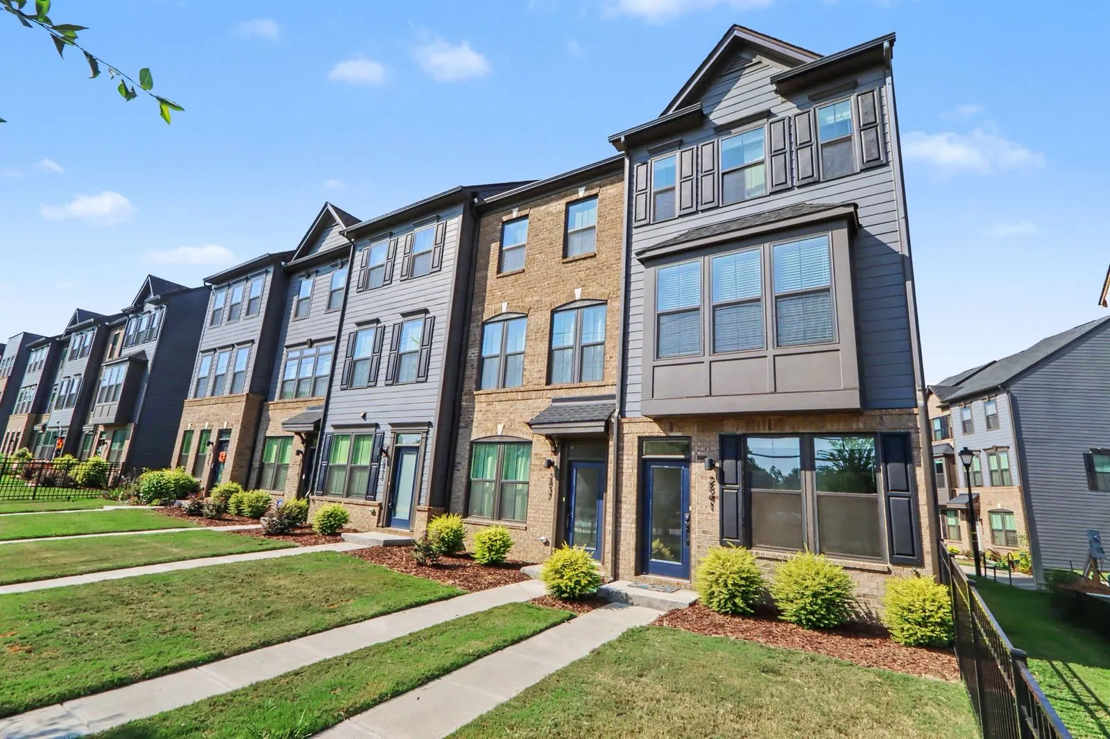 2841 Statesville Avenue, an end unit brick and gray-siding townhome in Northerly Townhomes